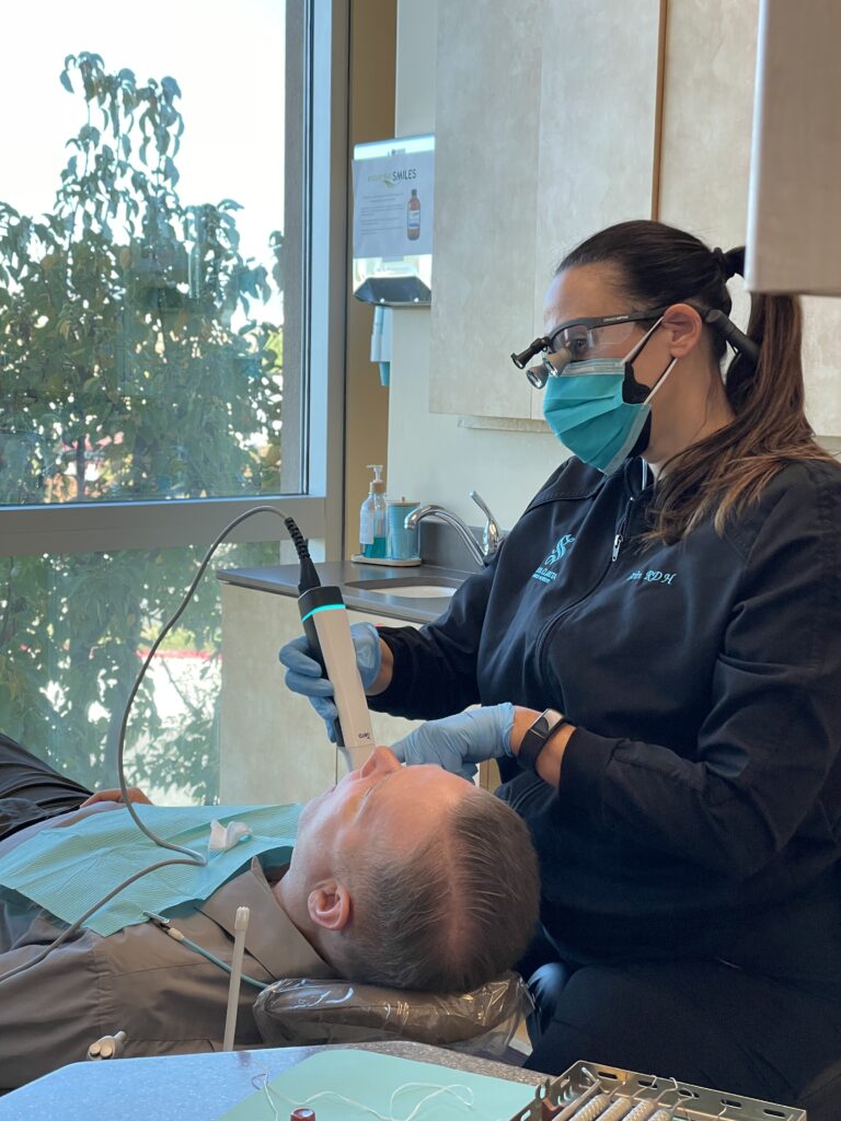 Hygienist scanning patients mouth